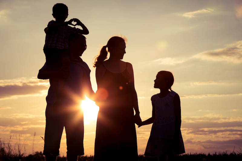 Silhouette of a happy family against a sunset