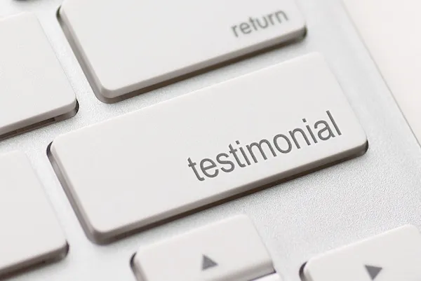 Up close image of a keyboard with a button titled 'testimonial'